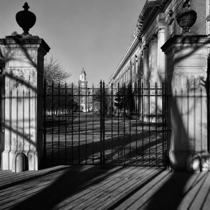 Closed gates at a university entrance, symbolizing mass student expulsions and the denial of educational rights in Bangladesh.